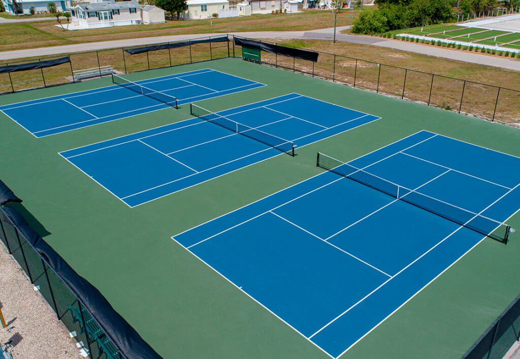 Aerial view of three tennis court at Bonita Terra fenced sports area near Fort Myers FL