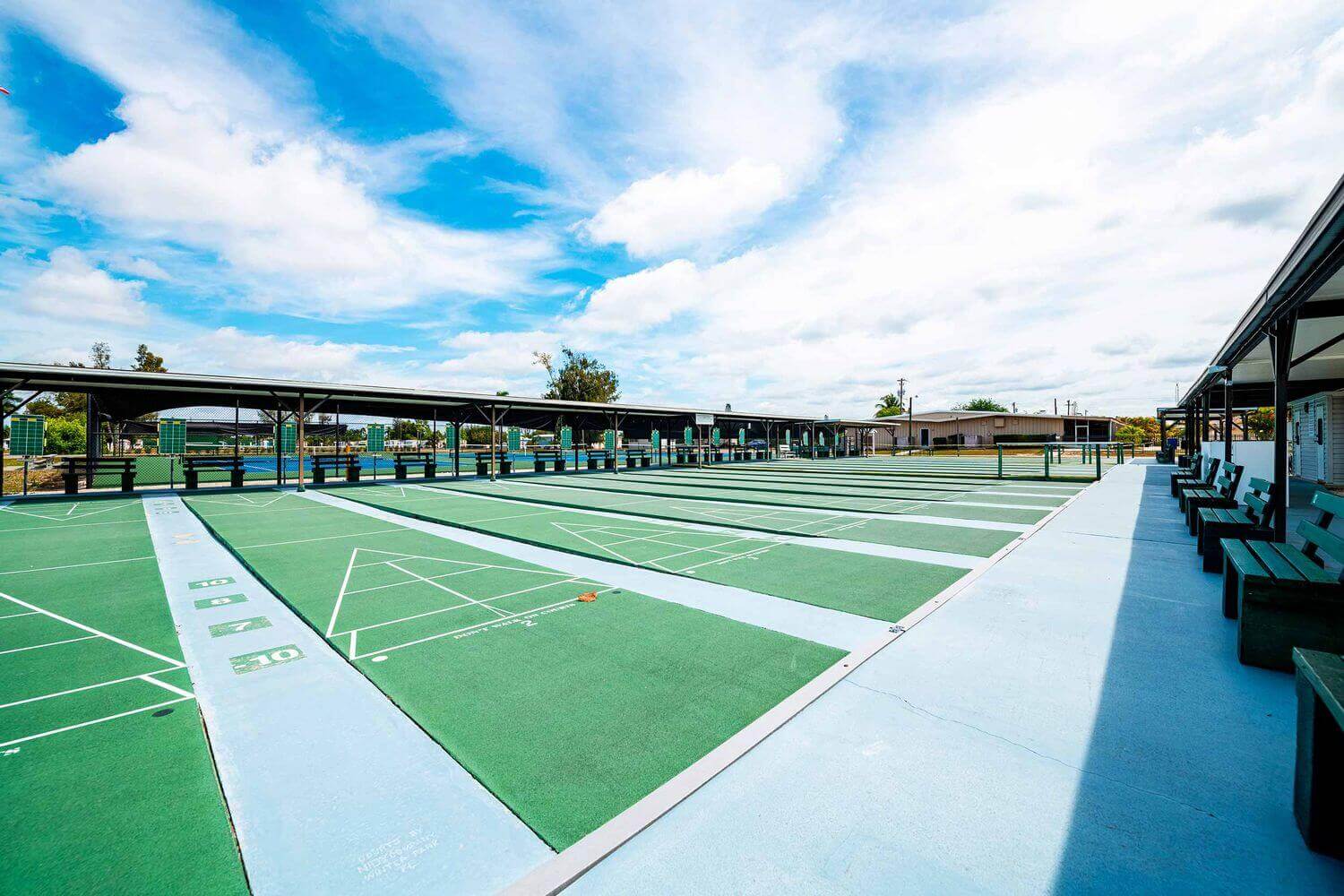 Shuffleboard courts with benches nearby at Bonita Terra community